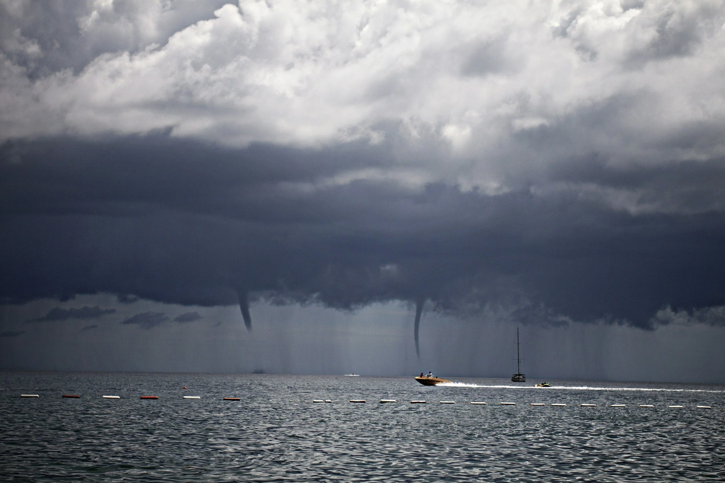 Storm clouds and waterspouts over the water